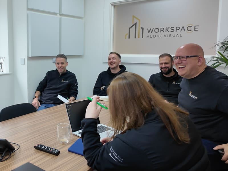 group of people sitting around a wooden table